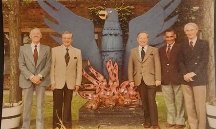 A group of men standing in front of a statue of a bird

AI-generated content may be incorrect.